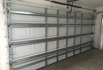 Steel sectional commercial garage door installed inside Great Neck NY warehouse