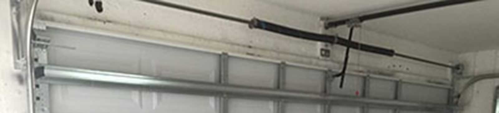 Steel sectional commercial garage door installed inside Great Neck NY warehouse