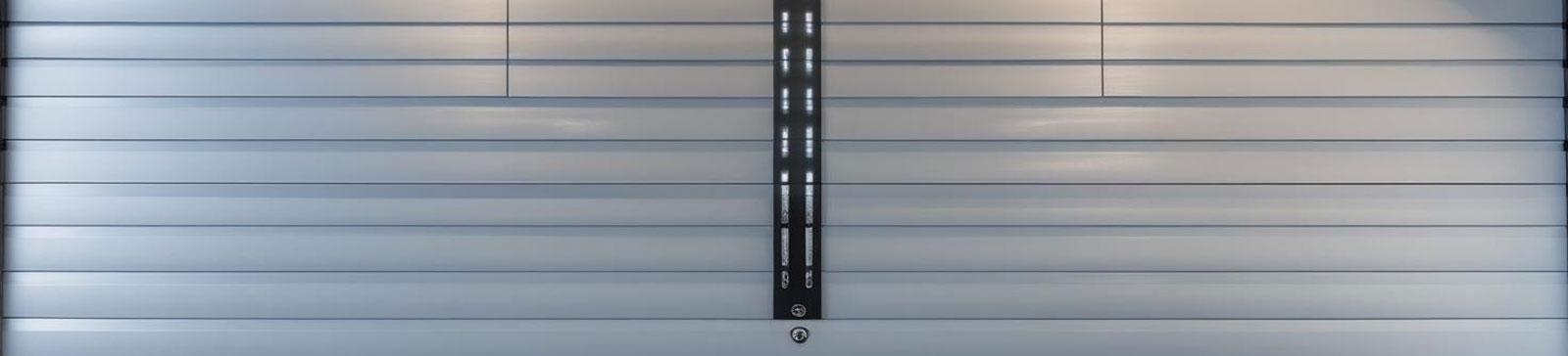 Modern custom garage door system with integrated lighting and tailored panels in Flushing, NY.