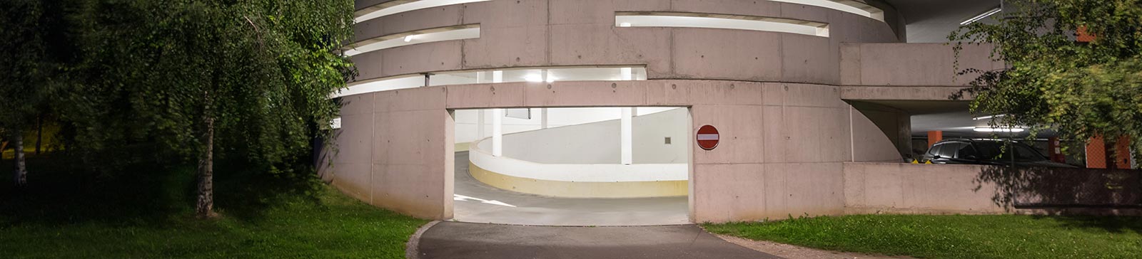 Well-lit modern commercial garage door exterior at night