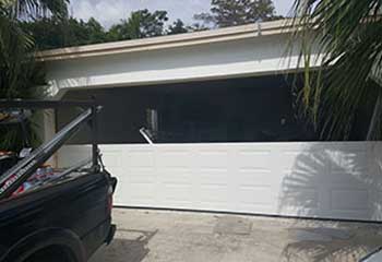 Installed steel sectional garage door viewed from the inside after replacement in Floral Park NY