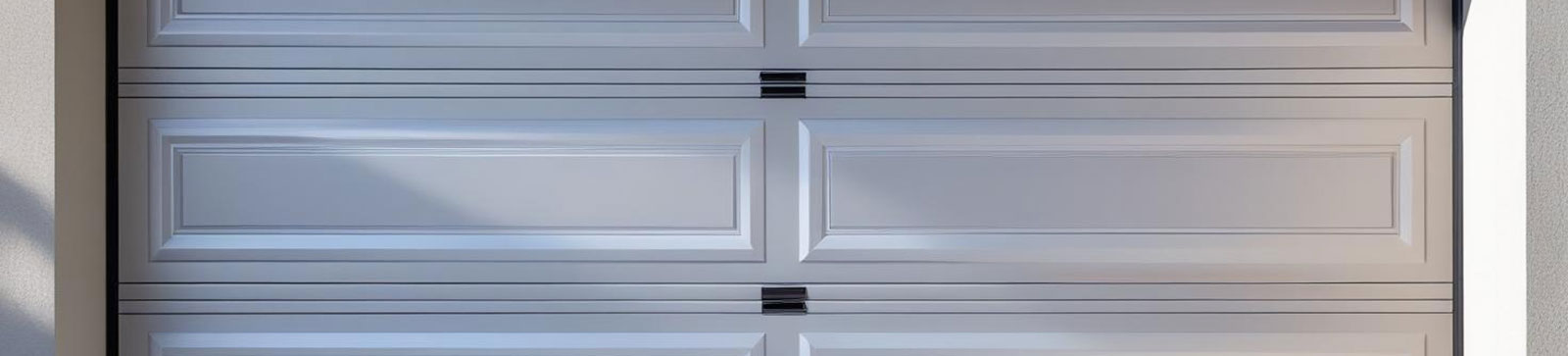 White overhead garage door in Flushing, NY, maintained for safety and performance.